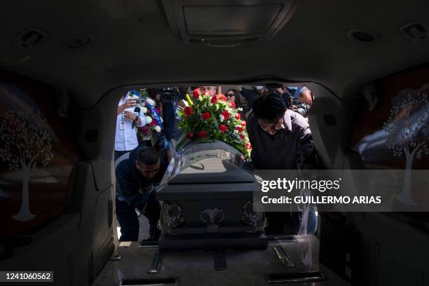 The coffin of asylum seeker Calory Archange, from Haiti, is loaded in a vehicle after a funeral service for two Haitian men who died in the city on...