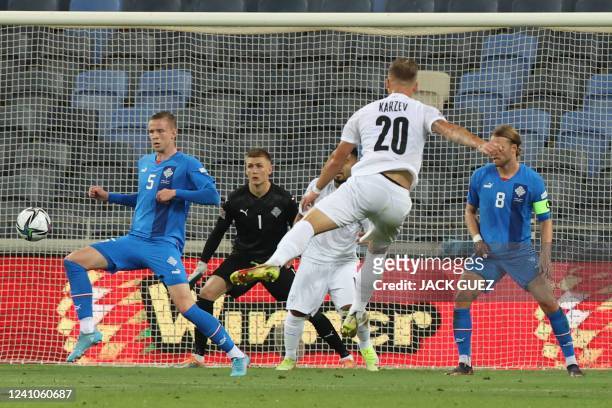 Israel's midfielder Eden Karzev attempts a shot during the UEFA Nations League - League B Group 2 - football match between Israel and Iceland at the...