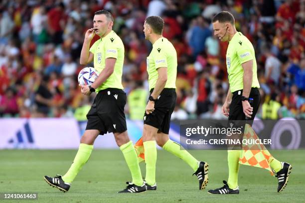 English referee Michael Oliver takes the ball as he leaves the pitch in the half-time during the UEFA Nations League, league A group 2 football match...