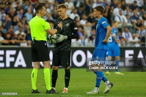 Latvian referee Andris Treimanis speaks with Iceland's goalkeeper Runar Alex Runarsson during the UEFA Nations League - League B Group 2 - football...