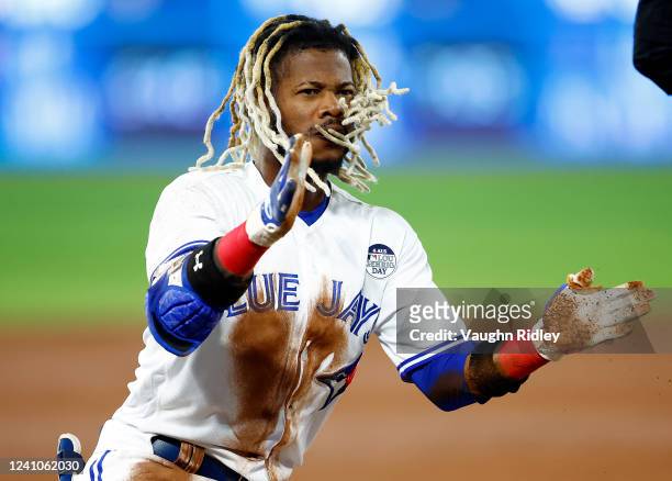 Raimel Tapia of the Toronto Blue Jays celebrates advancing to third base on a throwing error by Gavins Sheets of the Chicago White Sox in the third...