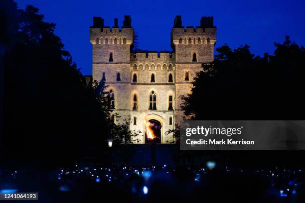 Crowd of local residents and visitors observes the lighting of a beacon on the Long Walk outside Windsor Castle to mark Queen Elizabeth II's Platinum...