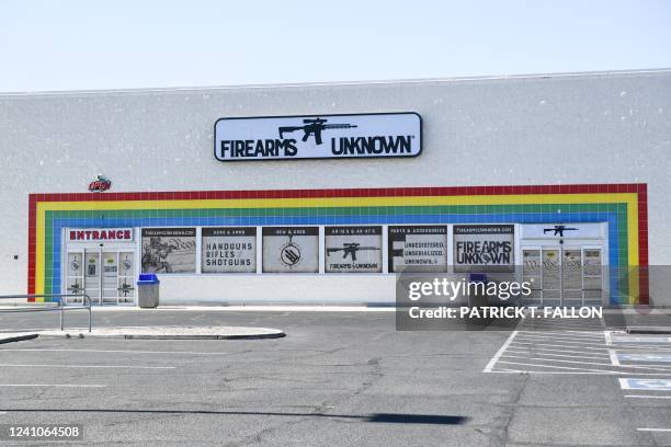 The silhouette AR-15 style rifle is displayed on signage for the Firearms Unknown Guns & Ammo gun store, in Yuma, Arizona on June 2, 2022. - US...