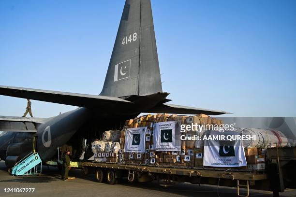 Soldiers load humanitarian aid material onto a C-130 plane at the Nur Khan airbase in Rawalpindi on June 3 to support Ukraine during the ongoing...