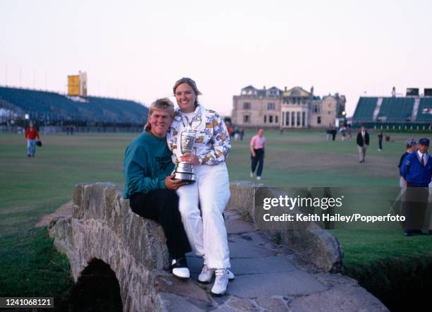 John Daly of the United States and his wife Paulette celebrate with the trophy on the Swilcan Bridge after winning the 124th Open Championship at the...