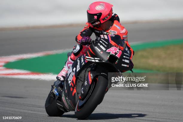 Aprilia Spanish rider Aleix Espargaro looks backwards as he rides during the first MotoGP free practice session of the Moto Grand Prix de Catalunya...
