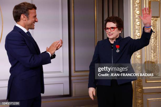 French President Emmanuel Macron applauds tennis legend Billie Jean King, of the US, after she was awarded with the Legion d'Honneur at the Elysee...