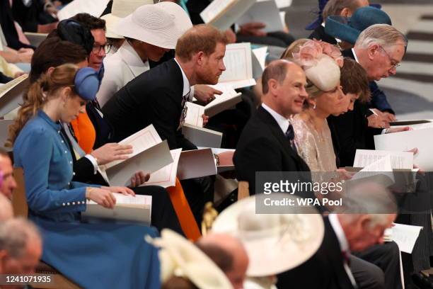 Prince Harry, Duke of Sussex reacts as he sits near Princess Beatrice, Prince Edward, Earl of Wessex, and Sophie, Countess of Wessex, during the...