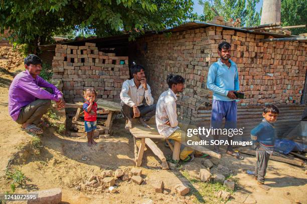 Migrant labours get emotional over their colleague, outside the temporary brick made house where assailants shot dead migrant Hindu labour who was...