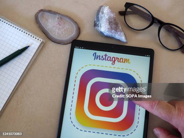 In this photo illustration, an Instagram logo seen displayed on a tablet.