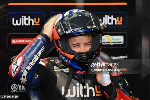 Yamaha RNF Italian rider Andrea Dovizioso fits his helmet during the second MotoGP free practice session of the Moto Grand Prix de Catalunya at the...