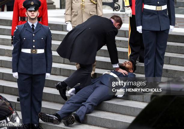 Member of the military faints on the steps ahead of the National Service of Thanksgiving for The Queen's reign at Saint Paul's Cathedral in London on...