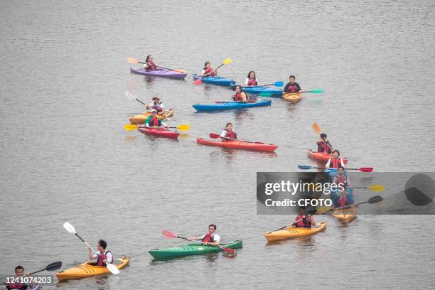 Children row boats to celebrate the Dragon Boat Festival at The Lixiang Lake National Wetland Park in Chongqing, China, June 3, 2022.