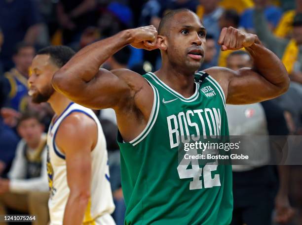 The Celtics Al Horford flexes to the crowd after Boston scored a late fourth quarter basket as they pulled away from Golden State for the victory....