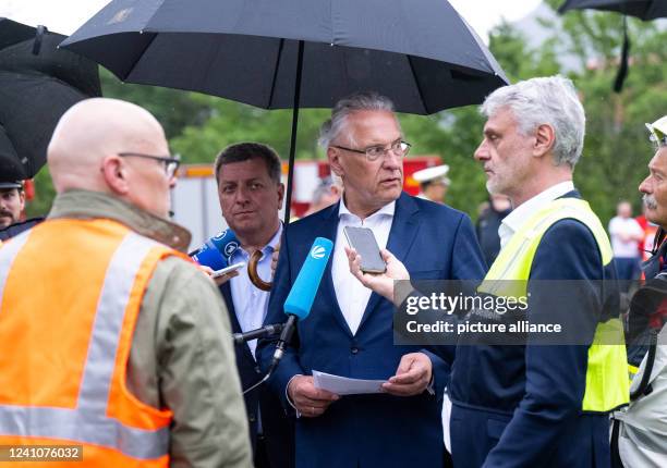 June 2022, Bavaria, Garmisch-Partenkirchen: Joachim Herrmann , Interior Minister of Bavaria, gets information after a serious train accident. At...