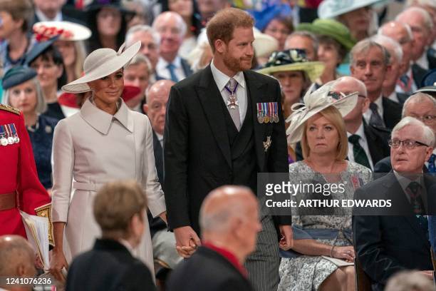 Britain's Prince Harry, Duke of Sussex and Britain's Meghan, Duchess of Sussex attend the National Service of Thanksgiving for The Queen's reign at...