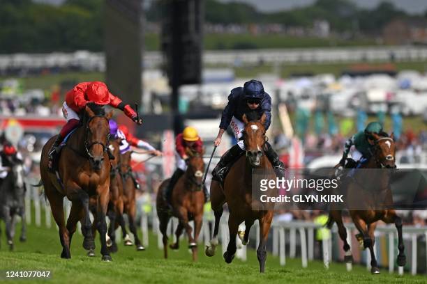 Jockey Ryan Moore rides Tuesday to victory over jockey Frankie Dettori on Emily Upjohn in the Oaks on the first day of the Epsom Derby Festival horse...