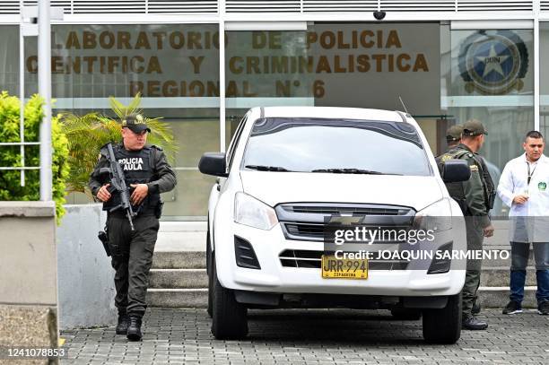 Police officers stand guard outside the Scientific and Forensic Police Laboratory in Medellin, Colombia, after the arrest of the suspects in the...