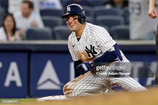 Jose Trevino of the New York Yankees reacts on third base after hitting a two-RBI triple against the Detroit Tigers during the fourth inning at...