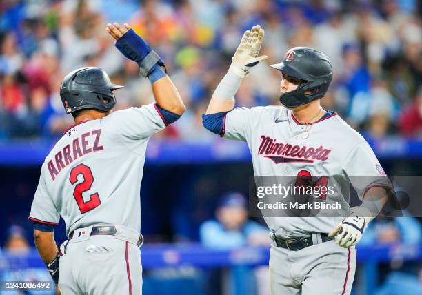 Jose Miranda of the Minnesota Twins celebrates his home run with Luis Arraez against the Toronto Blue Jays in the sixth inning during their MLB game...