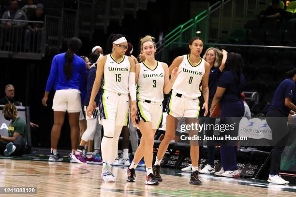 Allisha Gray, Marina Mabrey, Satou Sabally of the Dallas Wings walk on the court during the game against the Seattle Storm on June 3, 2022 at the...