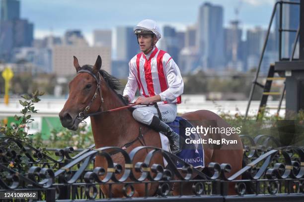 Jordan Childs returns to the mounting yard on Passive Aggressive after winning the TAB / ATA Trainers' Trust Handicap, at Flemington Racecourse on...