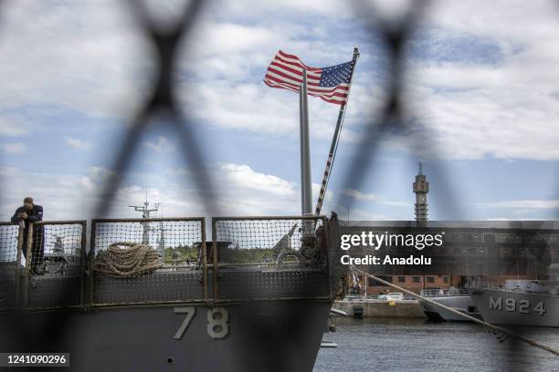 Flag waves as warships are seen moored in Frihamnen pier of Stockholm, Sweden on June 03, 2022. More than forty warships belonging to NATO countries...