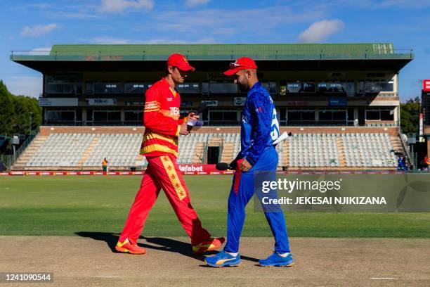 Zimbabwe captain Craig Ervine walks past Afghanistan captain Hashmatullah Shahidi after winning the toss and electing to bowl ahead of the first ODI...