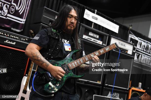 Guitarist Tommy Gibbons performs at the Krunch Kabinets booth during the NAMM Show on June 03 at the Anaheim Convention Center in Anaheim, CA.