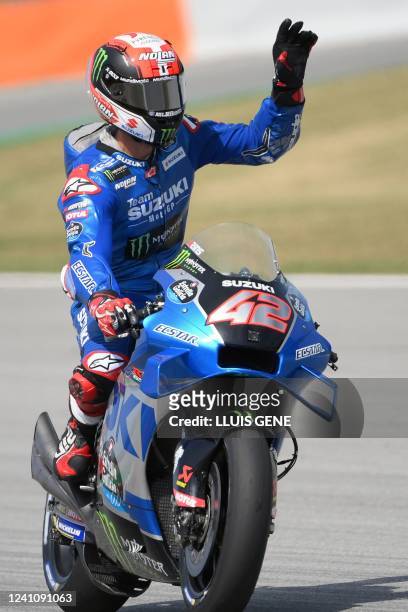 Suzuki Spanish rider Alex Rins waves as he rides after the third MotoGP free practice session of the Moto Grand Prix de Catalunya at the Circuit de...