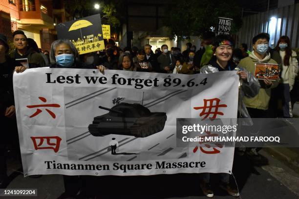 People march towards the Chinese consulate during a protest rally on the 33rd anniversary of the 1989 Tiananmen Square pro-democracy protests and...