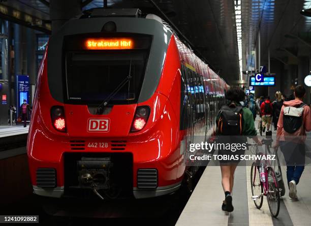 Travellers board a regional train to the northeastern Germany city of Stralsund at Berlin Central Station in Berlin on June 4, 2022. On June 1...
