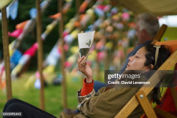 Visitor enjoys reading a book in a tent at the Hay Festival on June 4, 2022 in Hay-on-Wye, Wales.