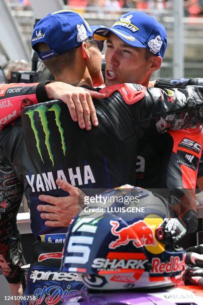 Aprilia Spanish rider Aleix Espargaro celebrates with Yamaha French rider Fabio Quartararo after taking the pole position after the MotoGP qualifying...