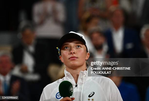 Poland's Iga Swiatek reacts during the trophy ceremony after winning against US' Coco Gauff at the end of their women's single final match on day...