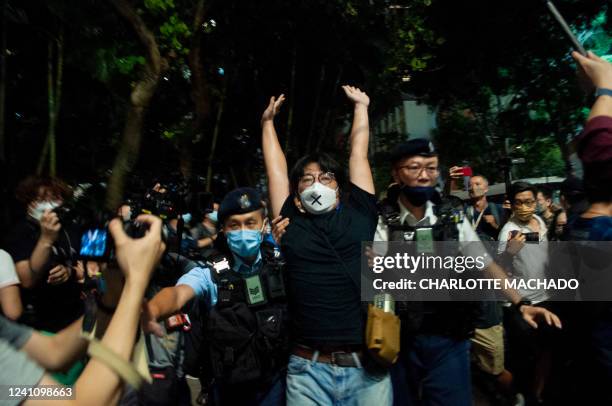 Veteran member of The League of Social Democrats is detained in the Causeway Bay district of Hong Kong on June 4 near the venue where Hong Kong...