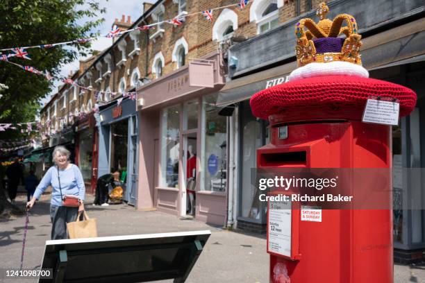 Crocheted knitted crown sits on top of a Royal Mail postal box in Dulwich Village during the long Bank Holiday weekend to celebrate the queen's...