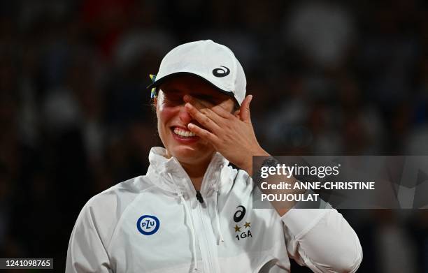 Poland's Iga Swiatek reacts during the trophy ceremony after winning against US' Coco Gauff at the end of their women's single final match on day...