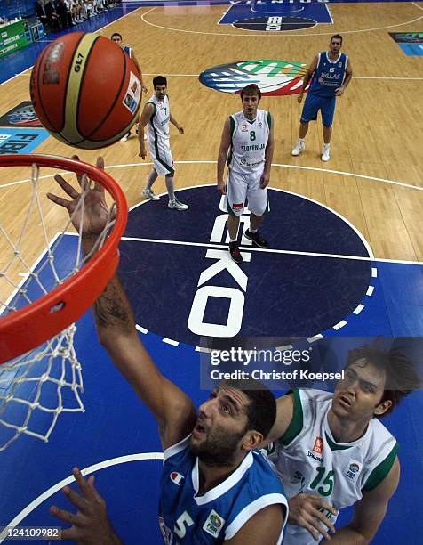 Ioannis Bourousis of Greece scores against Erazem Lorbek of Slovenia during the EuroBasket 2011 second round match between Slovenia and Greece at...