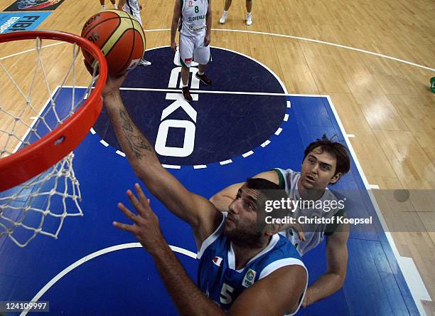 Ioannis Bourousis of Greece scores against Erazem Lorbek of Slovenia during the EuroBasket 2011 second round match between Slovenia and Greece at...