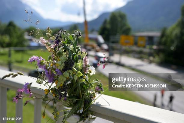 Flowers are seen attached to a balustrade of a bridge near the site of a train derailment near Burgrain, north of Garmisch-Partenkirchen, southern...