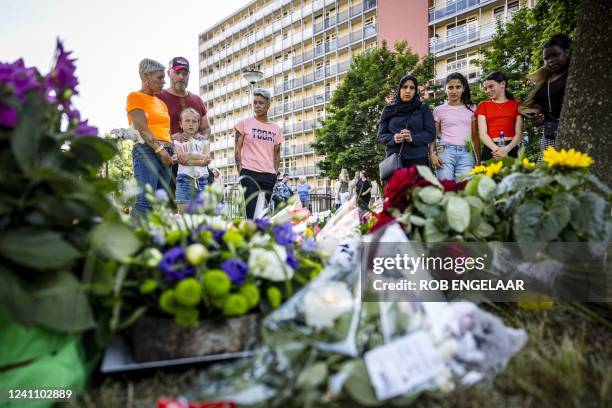 Members of the public stand beside flowers laid at a playground where 9-year-old Gino was last seen on the evening of June 1 in Kerkrade, on June 4,...