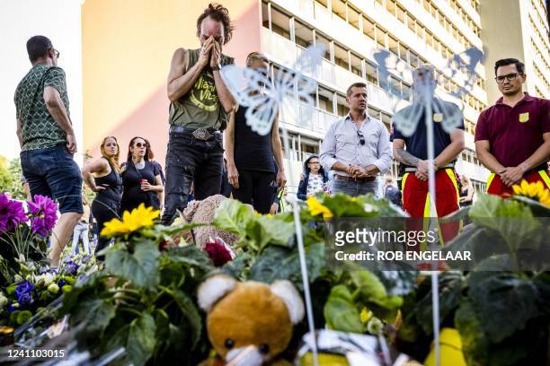 Members of the public stand beside flowers laid at a playground where 9-year-old Gino was last seen on the evening of June 1 in Kerkrade, on June 4,...