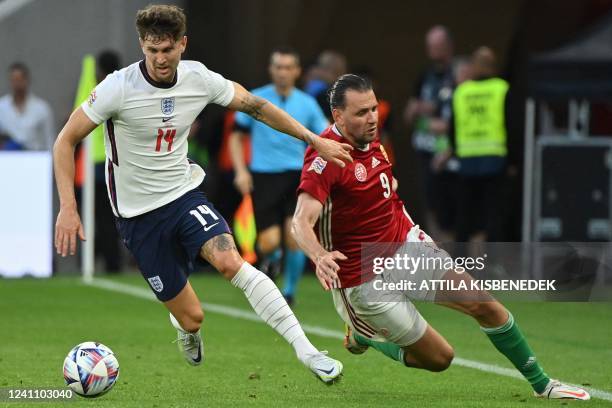 England's defender John Stones mand Hungary's forward Adam Szalai vie for the ball during the UEFA Nations League football match Hungary v England at...