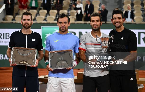 Austin Krajicek of the US, Croatia's Ivan Dodig, Netherlands' Jean-julien Rojer and Salvador's Marcelo Arevalo pose with their trophees at the end of...