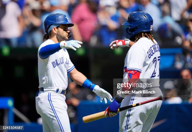 Bo Bichette of the Toronto Blue Jays celebrates his home run withe Vladimir Guerrero Jr. #27 against the Minnesota Twins in the first inning during...