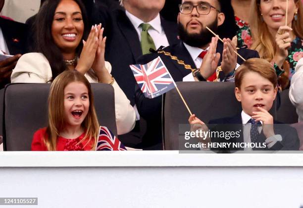 Britain's Princess Charlotte of Cambridge and Britain's Prince George of Cambridge react during the Platinum Party at Buckingham Palace on June 4,...