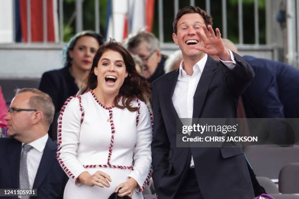 Britain's Princess Eugenie of York and Jack Brooksbank react during the Platinum Party at Buckingham Palace on June 4, 2022 as part of Queen...