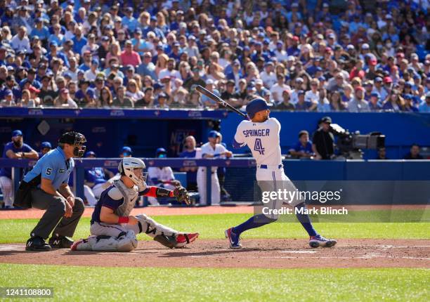 George Springer of the Toronto Blue Jays hits a sacrifice fly against the Minnesota Twins in the seventh inning during their MLB game at the Rogers...