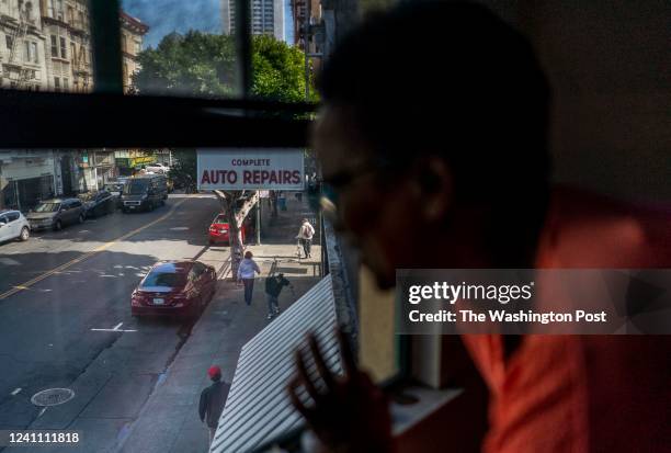 Community organizer Adama Bryant, founder of Weekend Adventures, sees a friend out her apartment window in the Tenderloin neighborhood of San...